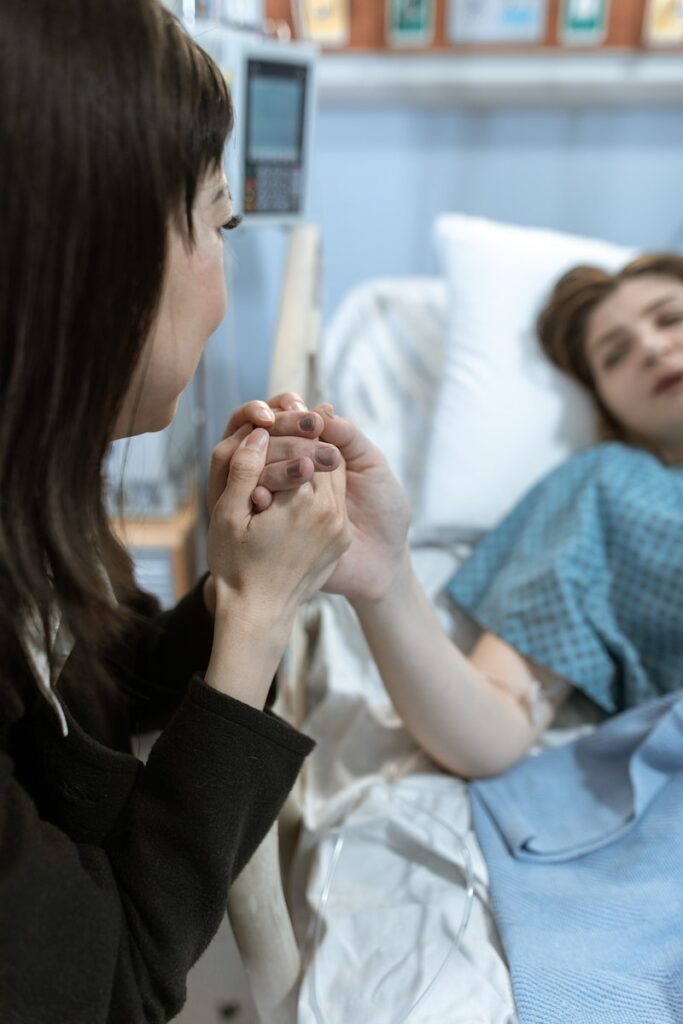 A Woman Holding a Patient's Hand