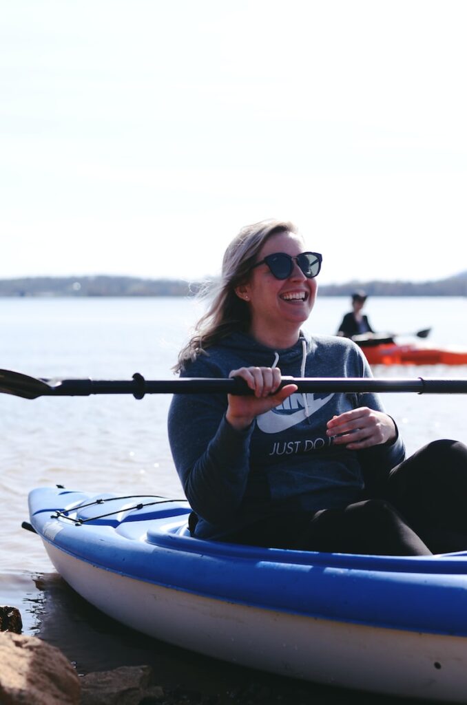 woman riding blue kayak